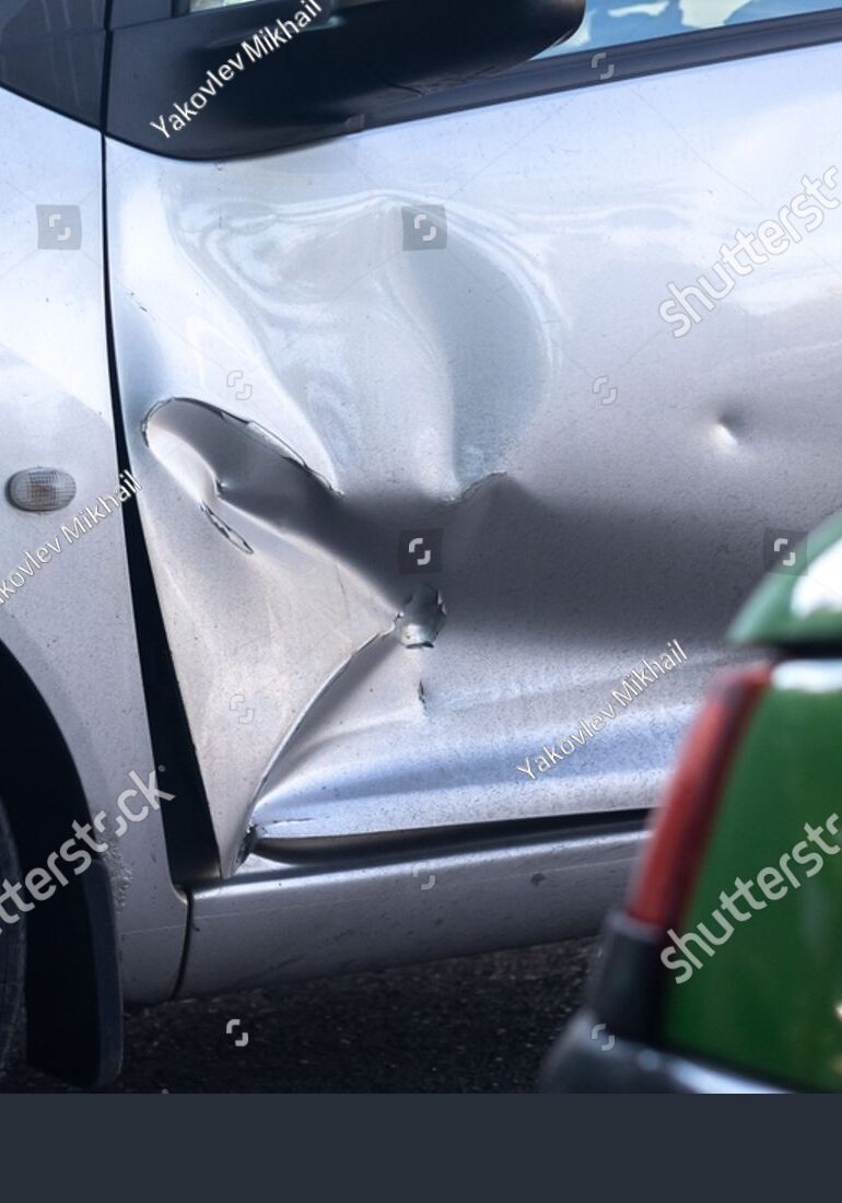 stock-photo-silver-car-with-a-large-dent-in-the-left-door-2682029363
